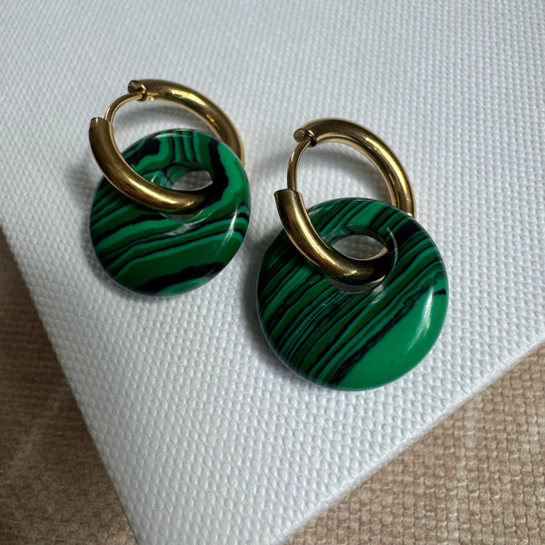 Gold hoops threaded with large resin green striped beads.