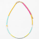 Dainty bead necklace in yellows, teals, pinks and whites.