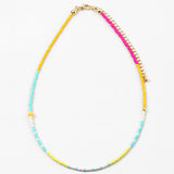 Dainty bead necklace in yellows, teals, pinks and whites.