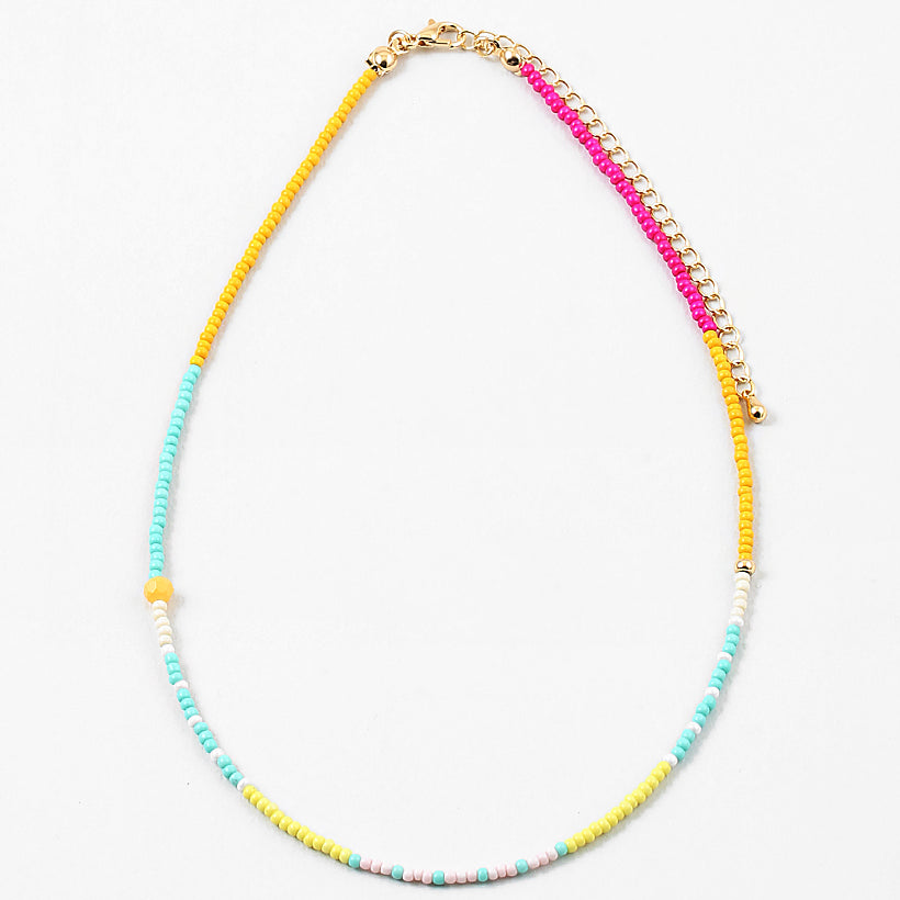 Dainty bead necklace in yellows, teals, pinks and whites.