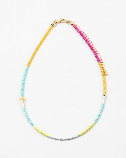 Dainty bead necklace in yellows, teals, pinks and whites.