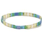 Blue, green and cream multicolored rectangle beaded bracelet on a white background