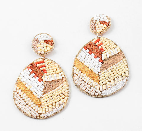 Large tear drop dangle earrings woven with natural fibers and cream, white and rust colored beads.