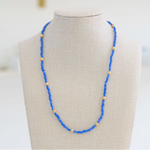 Blue bead necklace with accent gold spacer beads.
