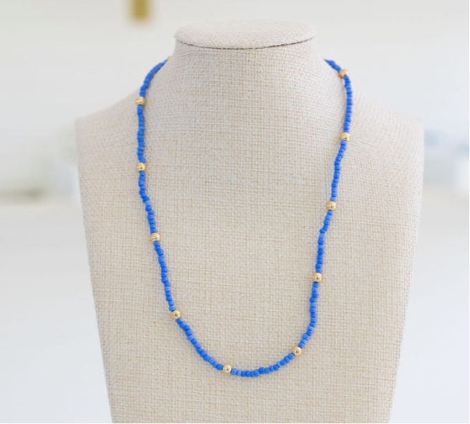 Blue bead necklace with accent gold spacer beads.