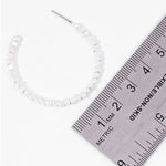Picture of a white bead hoop earring next to a ruler showing the size to be 3.5cm.