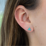 Picture of a model's ear displaying a three stone turquoise stone stud earrings.