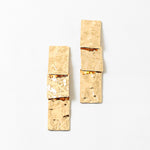 Hammered gold rectangles stacked into dangling earrings
