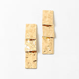 Hammered gold rectangles stacked into dangling earrings