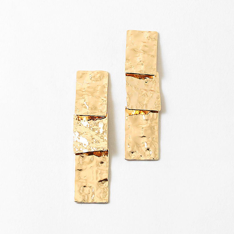 Hammered gold rectangles stacked into dangling earrings