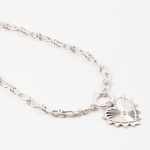 Silver necklace with a large heart charm on a white background
