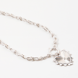 Silver necklace with a large heart charm on a white background