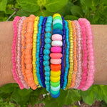 Beautiful set of 16 beaded bracelets. Bracelets are pink, orange, blue, turquoise, yellow and multicolored.