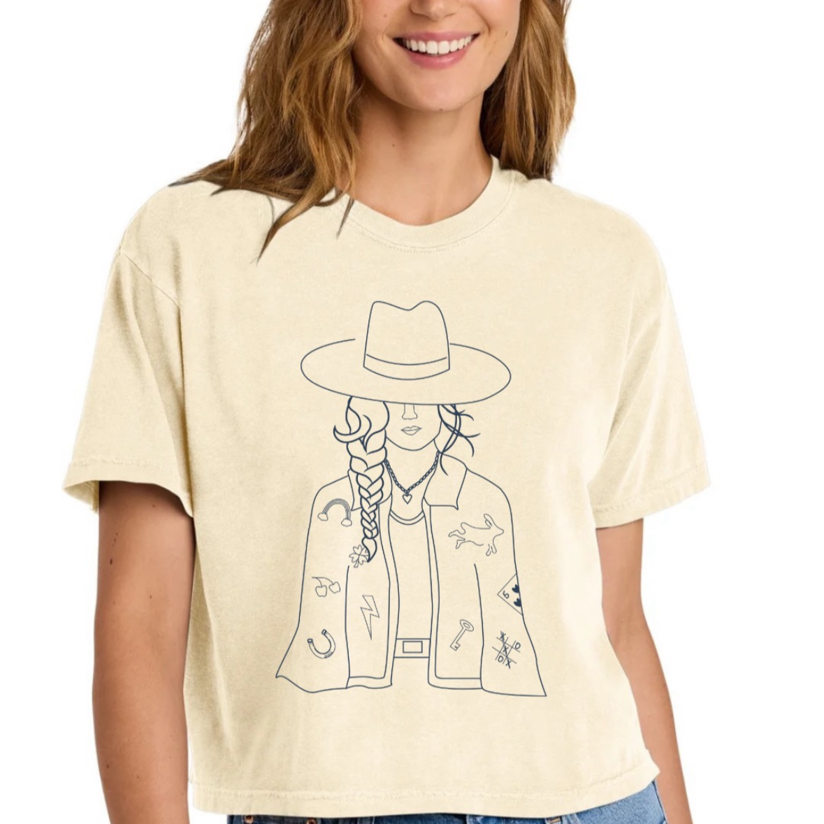 Woman wearing a light-colored t-shirt with a graphic design on a white background