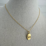 Picture of a dainty gold chain and an 11:11 gold charm