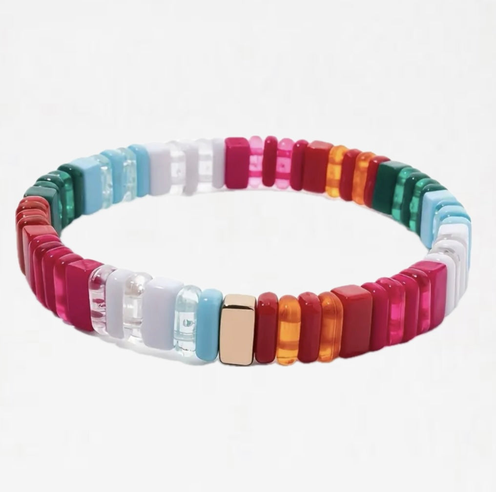 Bead bracelet in clear and solid colored beads in reds, whites, blues and greens