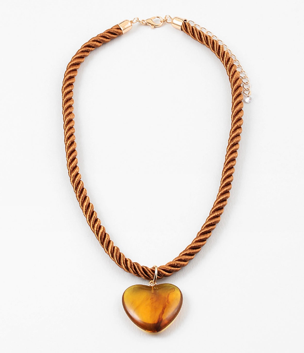 Necklace with a twisted brown cord and heart-shaped amber pendant on a white background