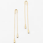Gold chain threader earrings with teardrop pendants on a white background