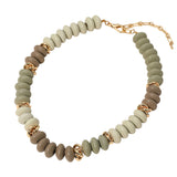 Necklace with beige beads and gold accents on a white background