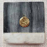 Hammered gold disc pendant.