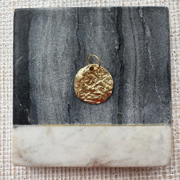 Hammered gold disc pendant.