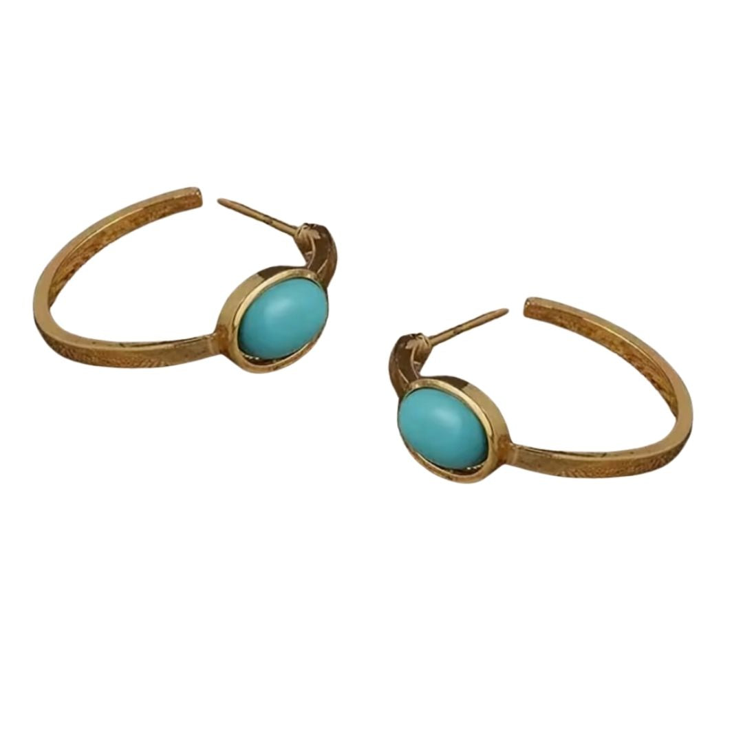 Gold hoop earrings with turquoise stones on a white background
