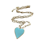 Gold chain necklace with a turquoise heart pendant on a white background