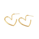 Gold heart-shaped hoop earrings on a white background