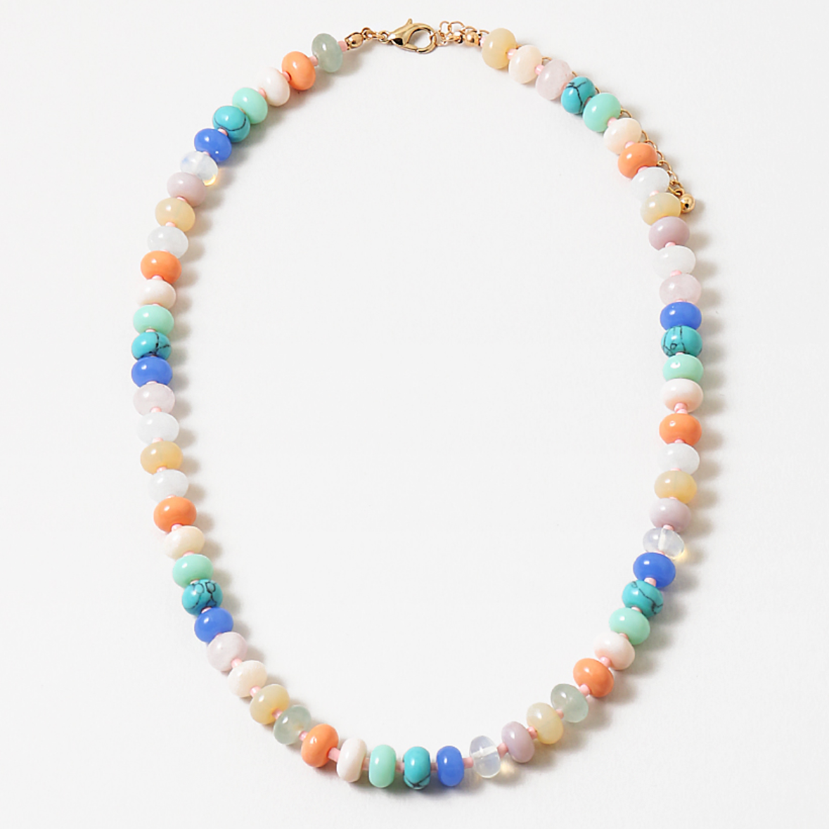 Multicolor semi-precious stone bead necklace in whites, cream, coral and blues.