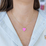 Model wearing a fine rectangle link chain with a pink enamel heart pendant.