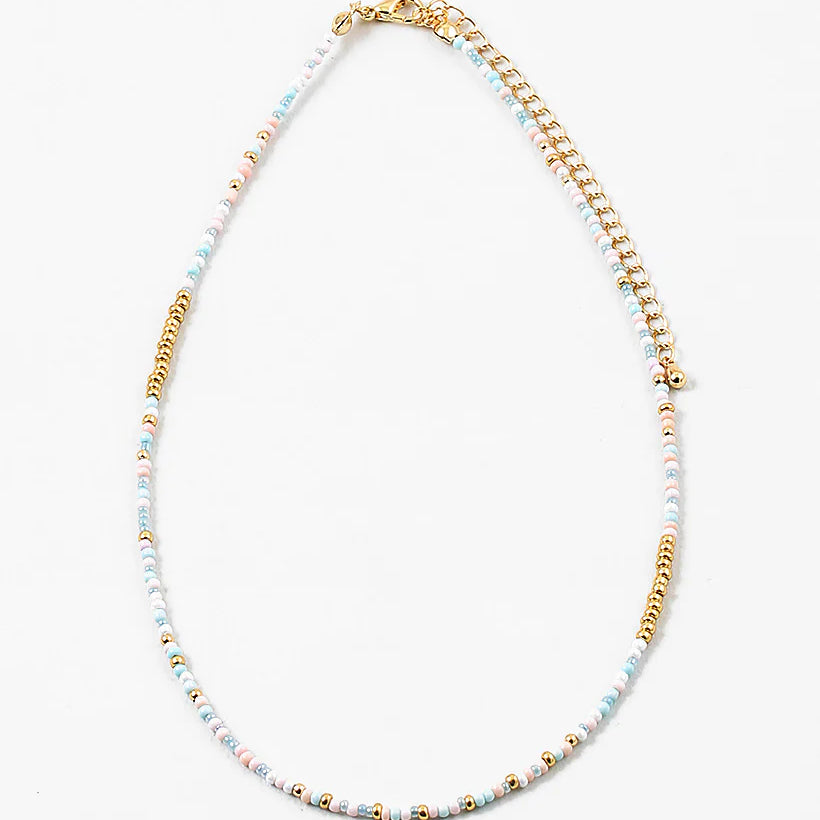 Delicate bead necklace made of white, gold and light blue beads.