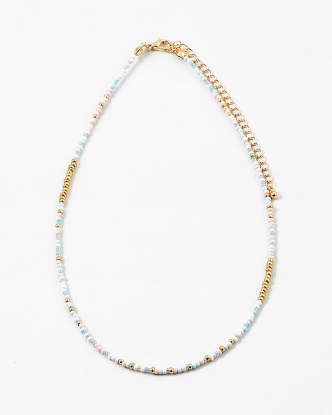 Delicate bead necklace made of white, gold and light blue beads.